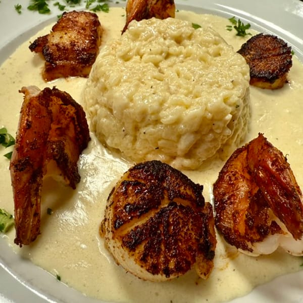 Blackened shrimp and scallops over creamy risotto