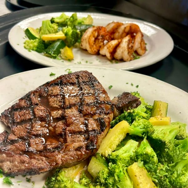 Grilled ribeye with seasonal vegetables and scallops