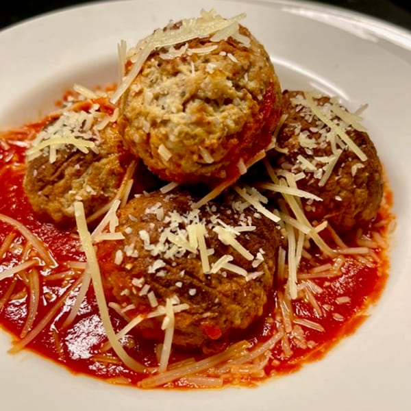 Meatballs in marinara with shaved Parmesan
